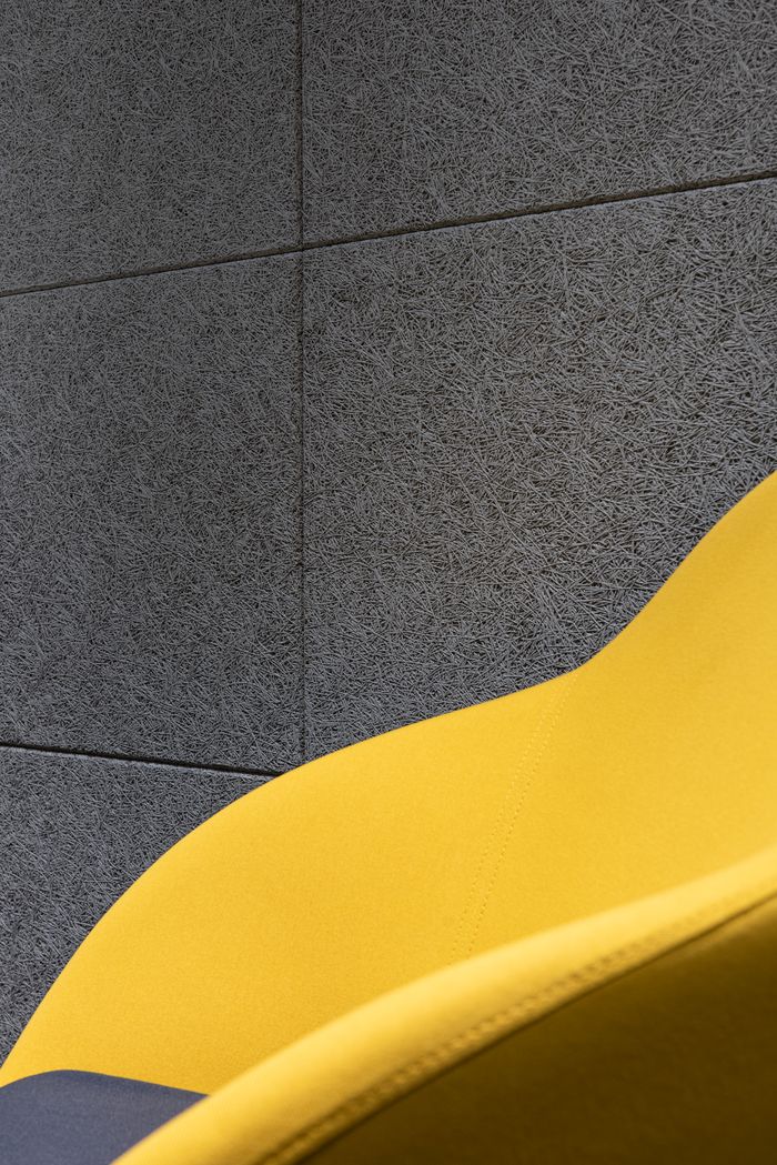 Mastering the First Impression: Your intriguing post title goes here Detail of comfortable bright chair with yellow fabric and cushion placed near gray textured wall in room of modern studio