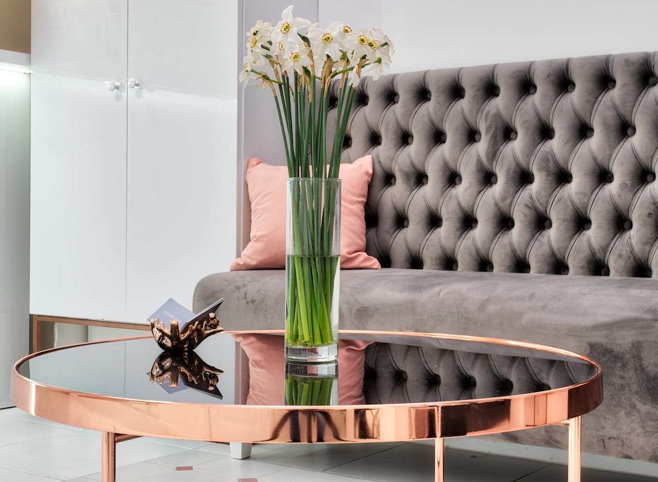 Crafting Captivating Headlines: Your awesome post title goes here Blossoming daffodils in vase with water reflecting on table against sofa with soft upholstery in lounge